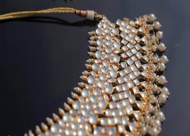 A slow motion shot of elegant Indian bridal jewelry featuring an ornate necklace, bangles, earrings, and headpiece
