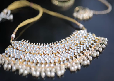 A slow motion shot of elegant Indian bridal jewelry featuring an ornate necklace, bangles, earrings, and headpiece