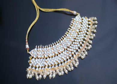A slow motion shot of elegant Indian bridal jewelry featuring an ornate necklace, bangles, earrings, and headpiece