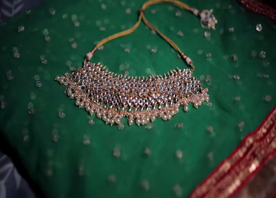 A slow motion shot of elegant Indian bridal jewelry featuring an ornate necklace, bangles, earrings, and headpiece