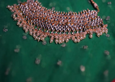 A slow motion shot of elegant Indian bridal jewelry featuring an ornate necklace, bangles, earrings, and headpiece