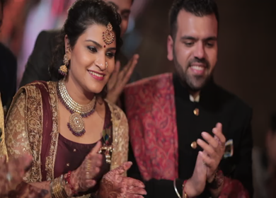 A Shot of Grooms Brother in law and sister clapping and being happy while engagement function of their brother at an Indian Function in New Delhi, India