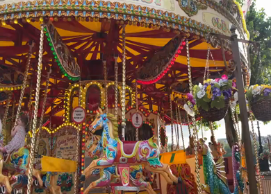 19th June 2024 : Children riding colorful carousel in London England