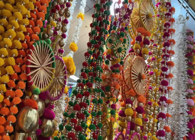 A Slow Motion shot of Colorful Flower Garlands Hanging at Market Shop in Delhi India