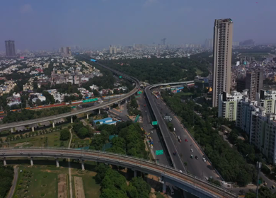 An aerial shot of the Delhi metro moving in New Delhi, India