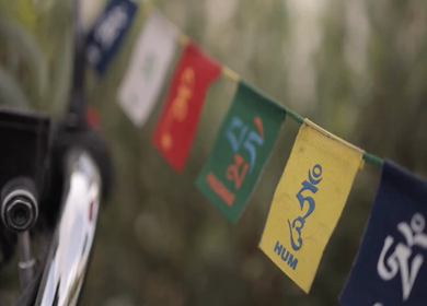 A Shot of Tibetan prayer flags tied on a bike's handle at Leh Ladakh,India