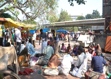 A shot of People and Beggars outside Hanuman Mandir 