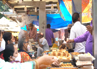 A static shot people buying sweets from a sweets shop