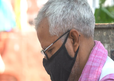 A close up shot of an old man wearing a COVID-19 mask at New Delhi, India