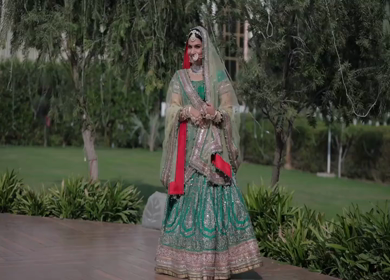 Indian Bride Posing for Wedding Photoshoot Wearing Traditional Bridal Attire and Jewelry at her wedding