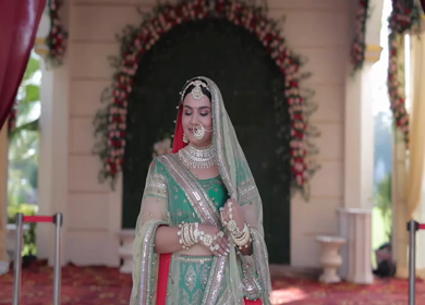 Indian Bride Posing for Wedding Photoshoot Wearing Traditional Bridal Attire and Jewelry at her wedding