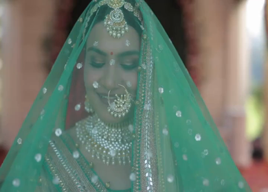 Indian Bride Posing for Wedding Photoshoot Wearing Traditional Bridal Attire and Jewelry at her wedding