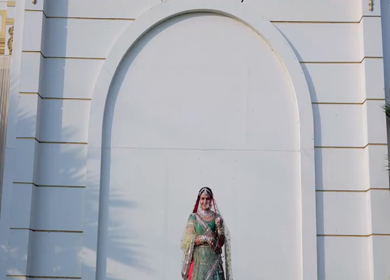 Indian Bride Posing for Wedding Photoshoot Wearing Traditional Bridal Attire and Jewelry at her wedding