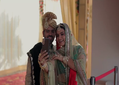 An Indian Couple on a Video Call with their Relatives during their Indian Wedding Ceremony