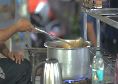 Indian Street Tea Vendor Pouring Hot Chai During Monsoon in Bhopal