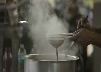 Indian Street Tea Vendor Pouring Hot Chai During Monsoon in Bhopal