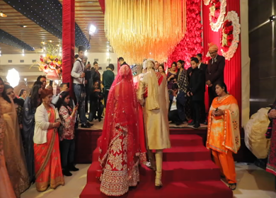 9th February,2019: A Shot of an Indian groom taking his bride to the stage at their Indian Wedding in New Delhi,India