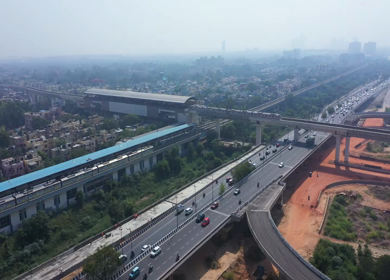An aerial shot of the Delhi metro leaving the station in Mayur Vihar,New Delhi, India