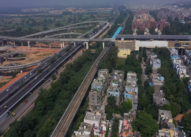 An aerial shot of the Delhi metro leaving the station at Mayur Vihar,New Delhi, India