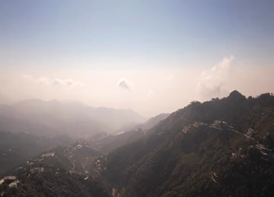 An aerial shot of Queen of the Hills which is Mussorrie being surrounded by Greenery and Sky