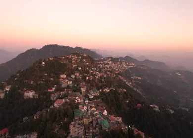 An aerial shot of Queen of the Hills which is Mussorrie being surrounded by Greenery and Sky