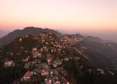 An aerial shot of Queen of the Hills which is Mussorrie being surrounded by Greenery and Sky