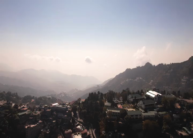 An aerial shot of Queen of the Hills which is Mussorrie being surrounded by Greenery and Sky