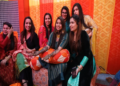 New Delhi,NCR,India-8th February,2019: Shot of Indian Bride friends cheering on camera at her Mehendi function in New Delhi, India