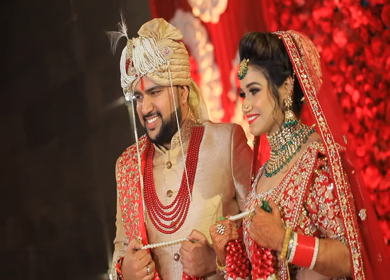 New Delhi,NCR,India-9th February,2019: Shot of an Indian Bride and Groom posing towards camera while holding their jai mala at their Indian wedding in New Delhi,India