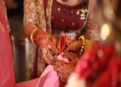 New Delhi,NCR,India-9th February,2019: Shot of an Indian Grooms sister tying the marriage bandhan or wedding knot or jor bandhan in an Indian wedding