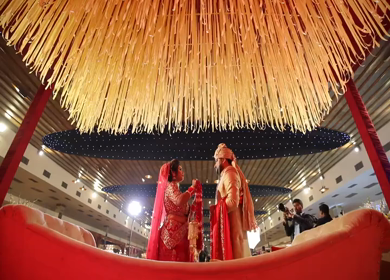 9th February, 2019: A shot of the happy bride and groom exchanging garlands at their wedding in New Delhi, India