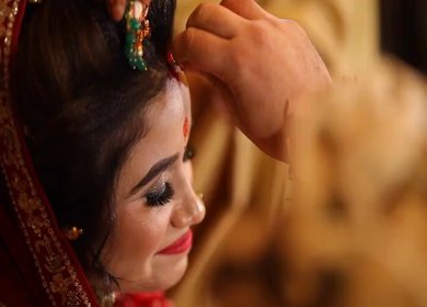 A shot of an Indian Bride getting Sindoor filled by her husband at an Indian Wedding in New Delhi,India