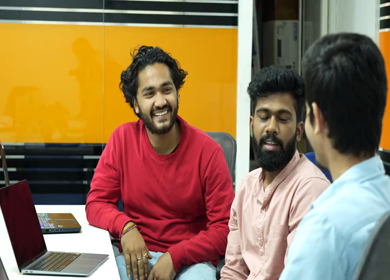 A shot of Indian colleagues having a casual conversation in their office conference room 
