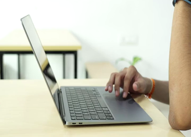 A shot of an Indian boy working with concentration on computer