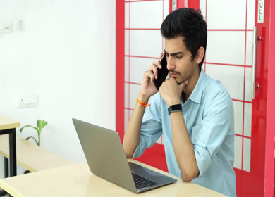 A shot of an Indian boy working with concentration on computer