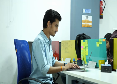 A shot of an Indian boy working with concentration on computer