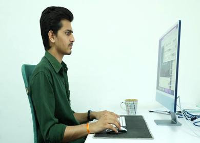 A shot of an Indian boy working with concentration on computer