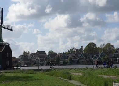 20th March 2026 : Slow Motion Tourists Walking Near Traditional Dutch Houses in Amsterdam