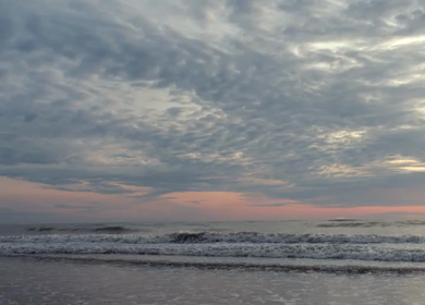 Slow motion shot of gentle ocean waves rolling onto the beach in Phuket, Thailand