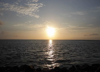 A shot of the sun rising over the ocean in India