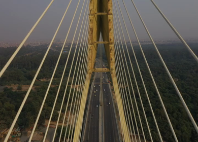 An aerial shot of the Signature Bridge with cars moving in New Delhi, India