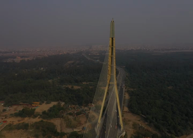 An aerial shot of the Signature Bridge with cars moving in New Delhi, India