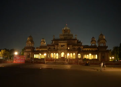 Timelapse view of Albert Hall Museum illuminated at night with flowing traffic in Jaipur, India