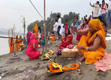 26th October 2025 : Women Performing Chhath Puja Ritual at Yamuna River Kalindi Kunj Delhi India