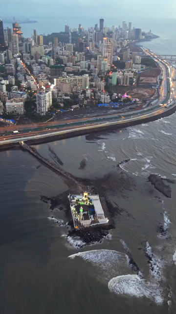 Vertical Aerial Evening View of Mumbai Coastal Road Haji Ali Dargah and Mumbai Skyline Maharashtra