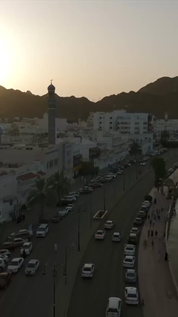 Vertical Aerial Evening View of Mutrah Corniche Muscat Oman with Hajar Mountains
