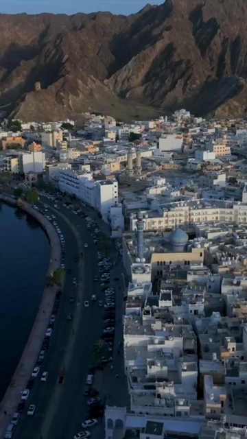 Vertical Aerial Evening View of Mutrah Corniche Muscat Oman with Hajar Mountains