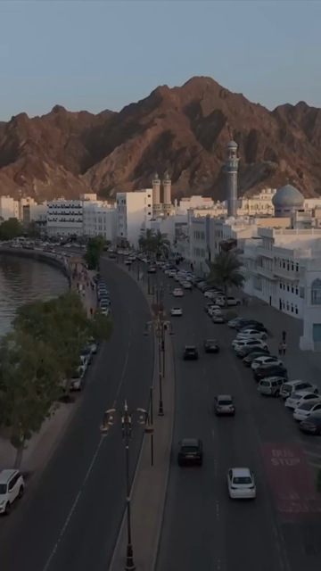 Vertical Aerial Evening View of Mutrah Corniche Muscat Oman with Hajar Mountains