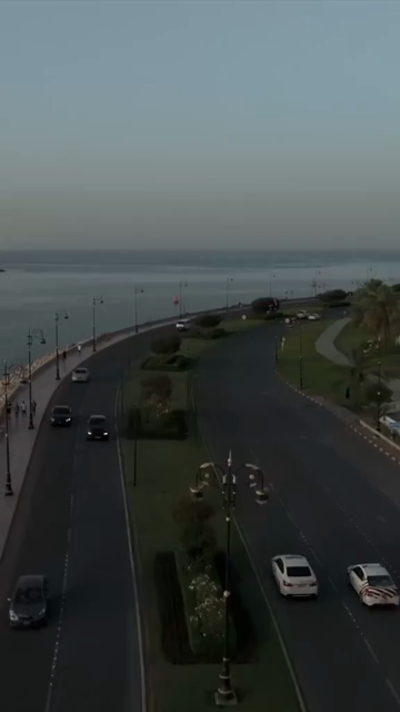 Vertical Aerial Evening View of Mutrah Corniche Muscat Oman with Hajar Mountains