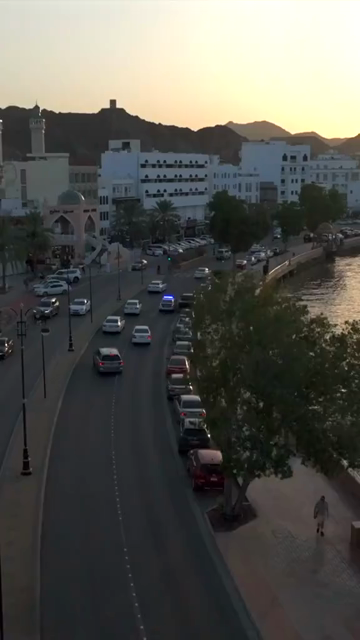 Vertical Aerial Evening View of Mutrah Corniche Muscat Oman with Hajar Mountains